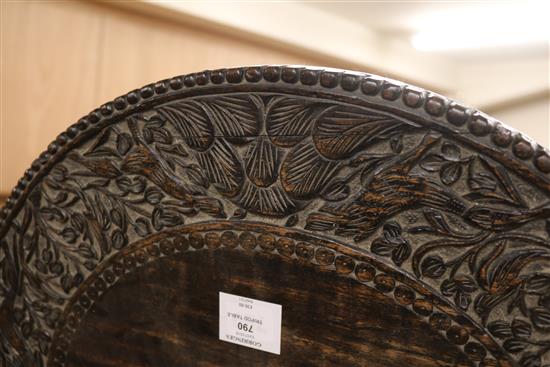 A carved tripod table W.55cm